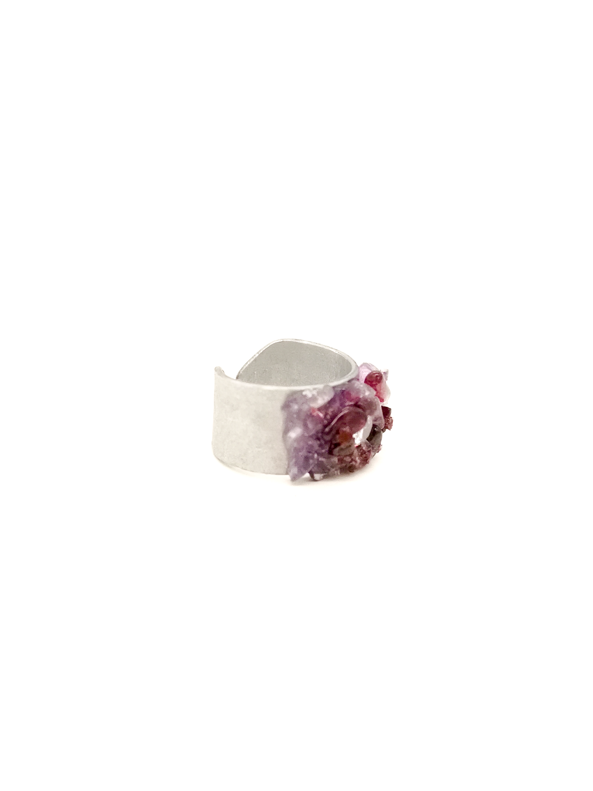 Silver ring with purple gemstone on a white background