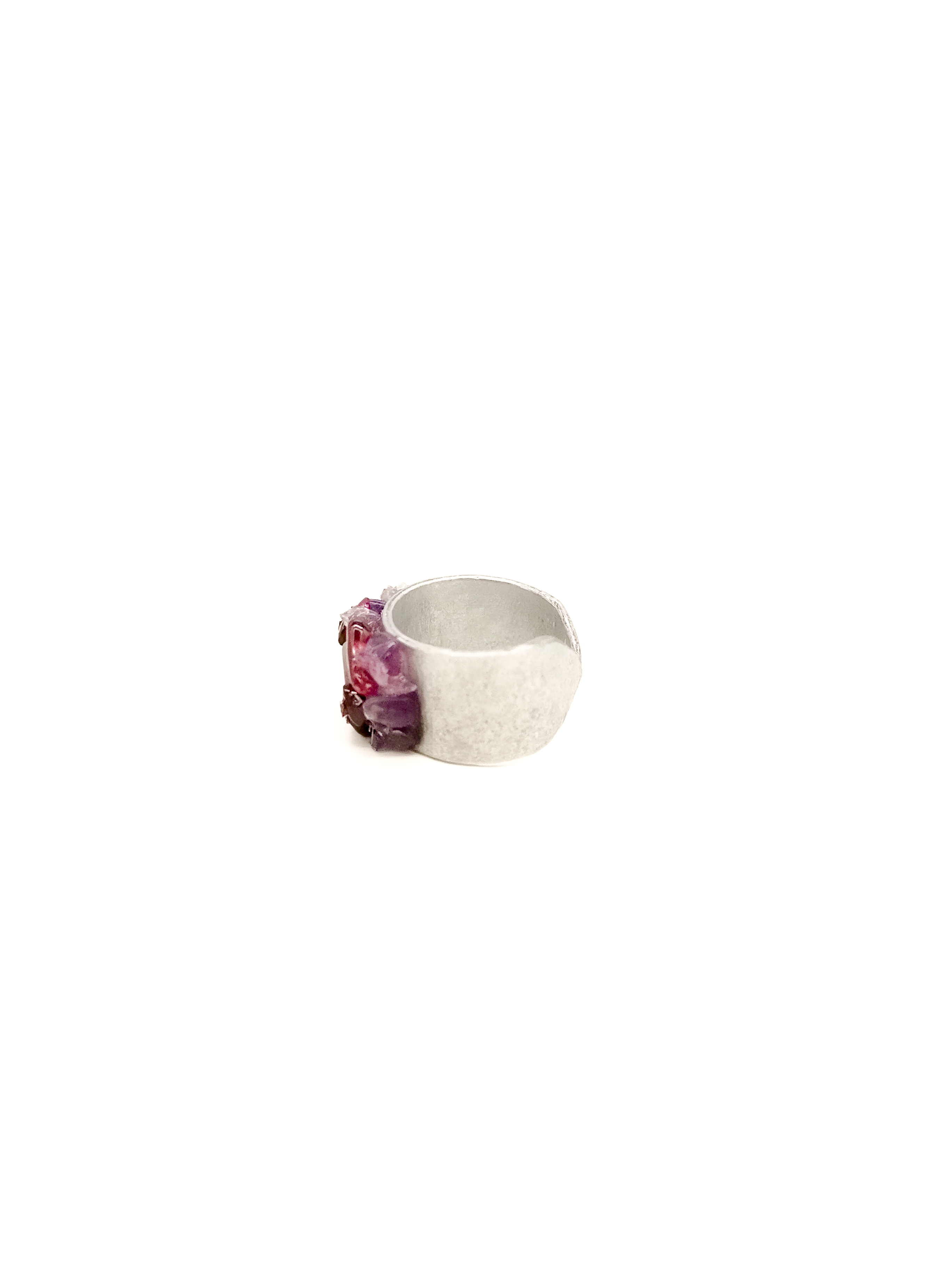Silver ring with a purple gemstone on a white background