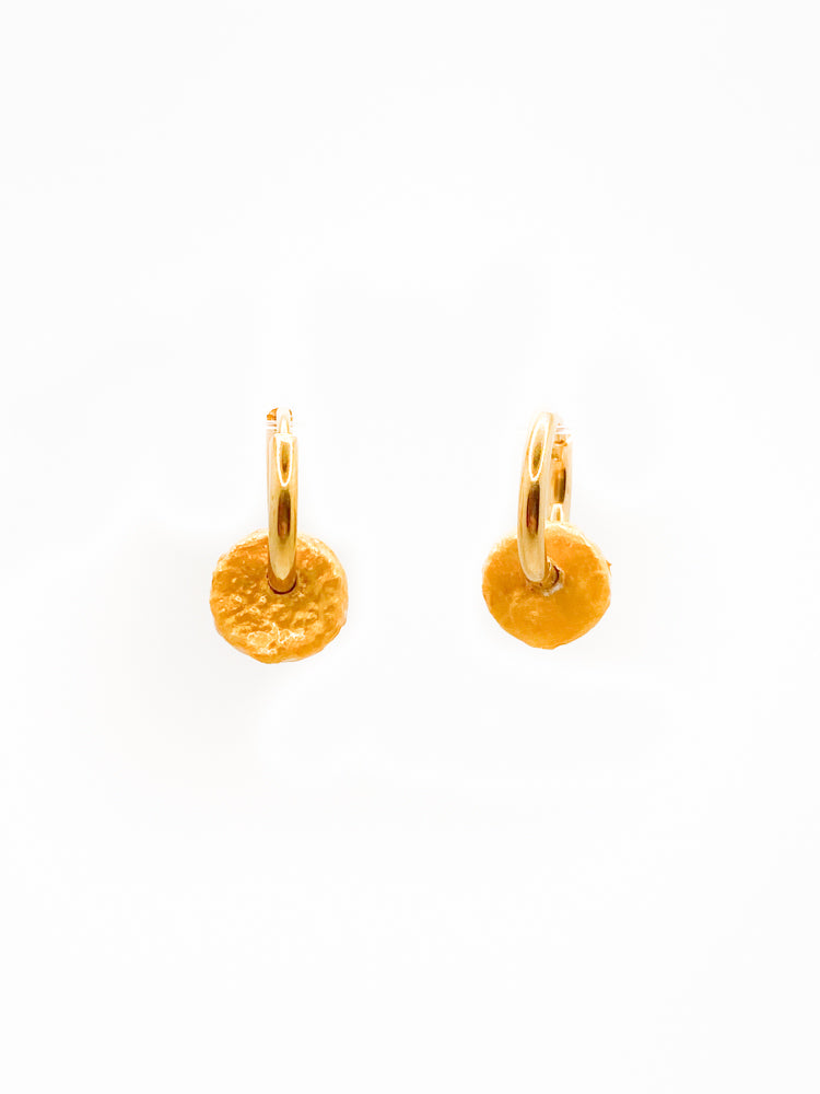Tiny hoops gold Aster orange skin front organic jewelry