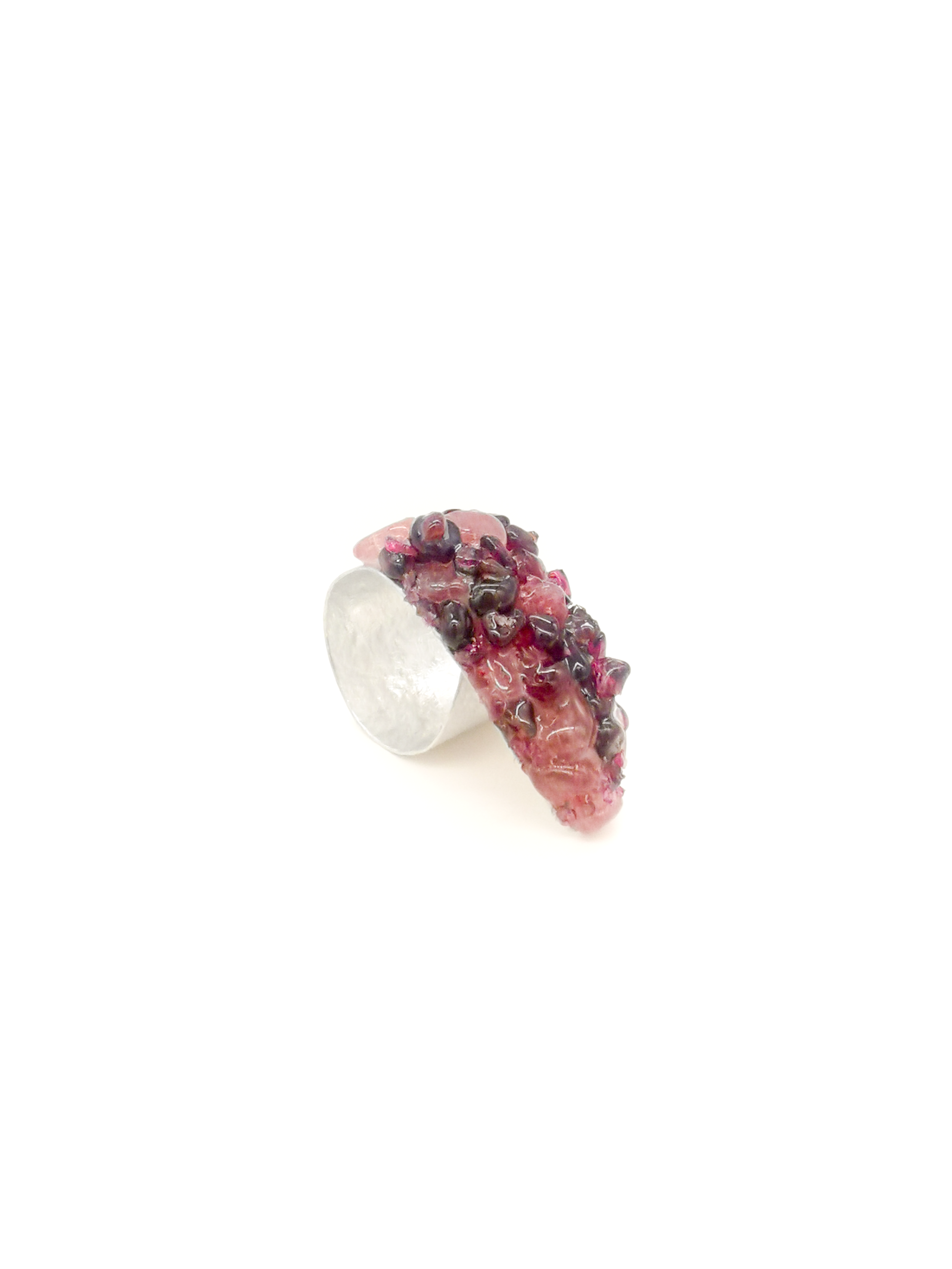 Silver ring with pink gemstone on a white background